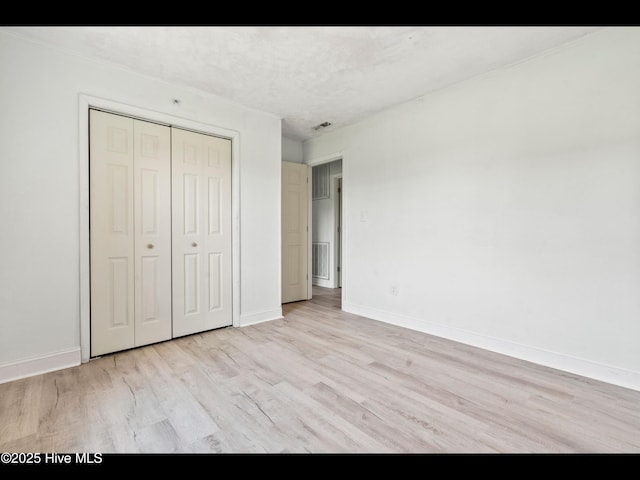 9348 NC Highway 210, Rocky Point, NC 28457 - unfurnished bedroom with light wood-style floors, baseboards, and a closet