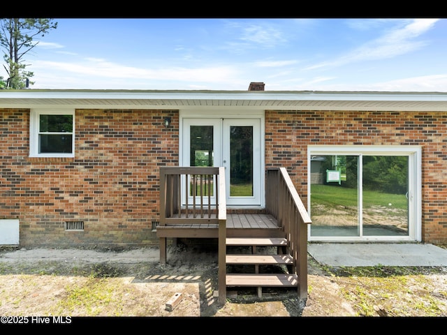 9348 NC Highway 210, Rocky Point, NC 28457 - view of exterior entry featuring crawl space, french doors, and brick siding