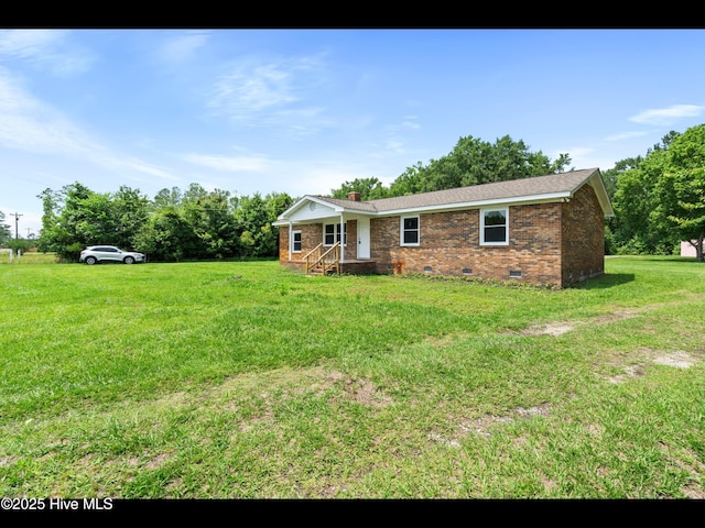 9348 NC Highway 210, Rocky Point, NC 28457 - view of front of house with crawl space, brick siding, a chimney, and a front lawn