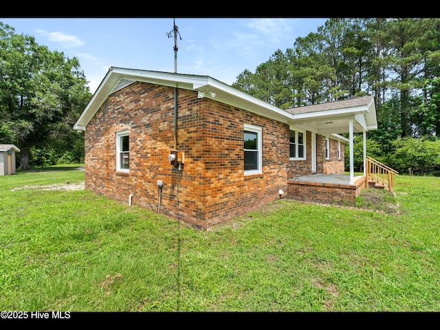9348 NC Highway 210, Rocky Point, NC 28457 - view of property exterior with a lawn, brick siding, and covered porch
