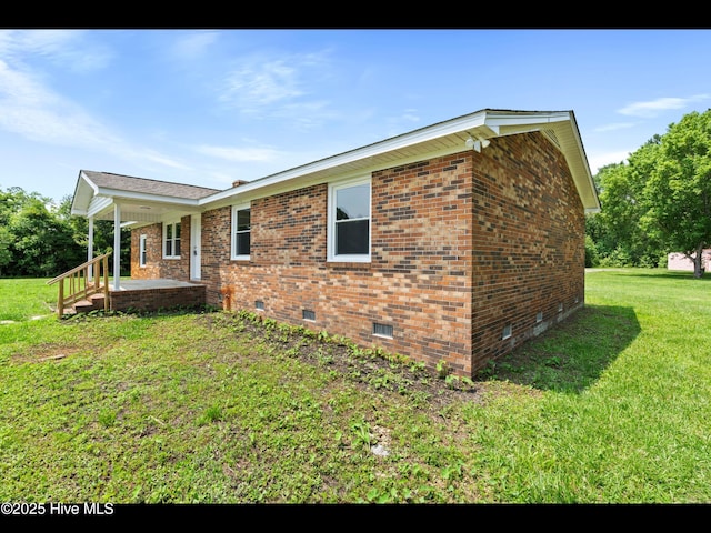 9348 NC Highway 210, Rocky Point, NC 28457 - view of property exterior featuring crawl space, a yard, and brick siding