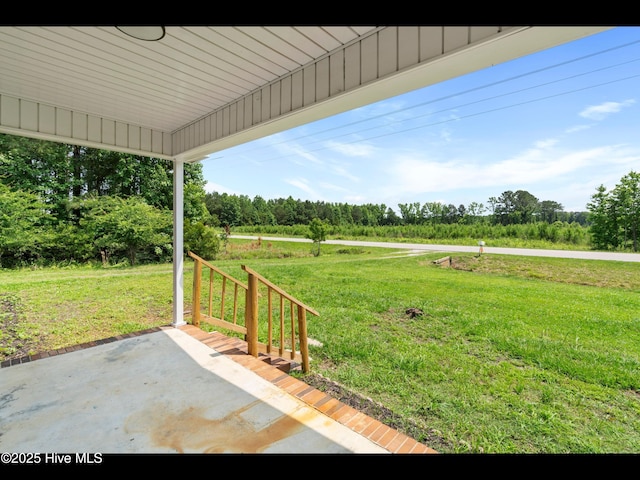 9348 NC Highway 210, Rocky Point, NC 28457 - view of green lawn with a patio and view of scattered trees