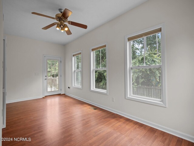 empty room featuring ceiling fan and hardwood / wood-style floors