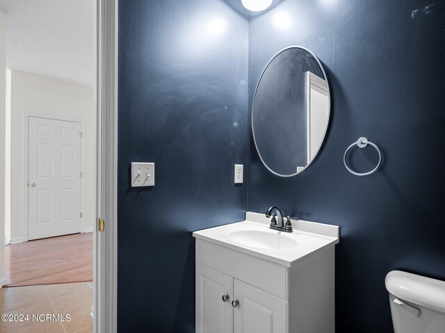 bathroom featuring hardwood / wood-style floors, vanity, and toilet