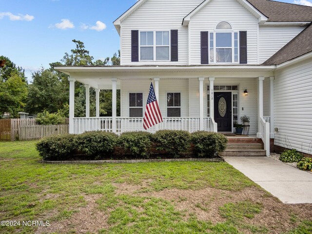 view of front of house with a front lawn and covered porch