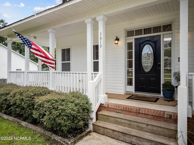 view of exterior entry with covered porch