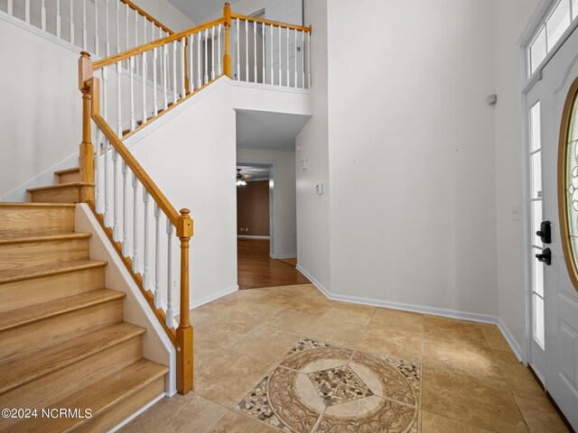 foyer with a high ceiling and ceiling fan