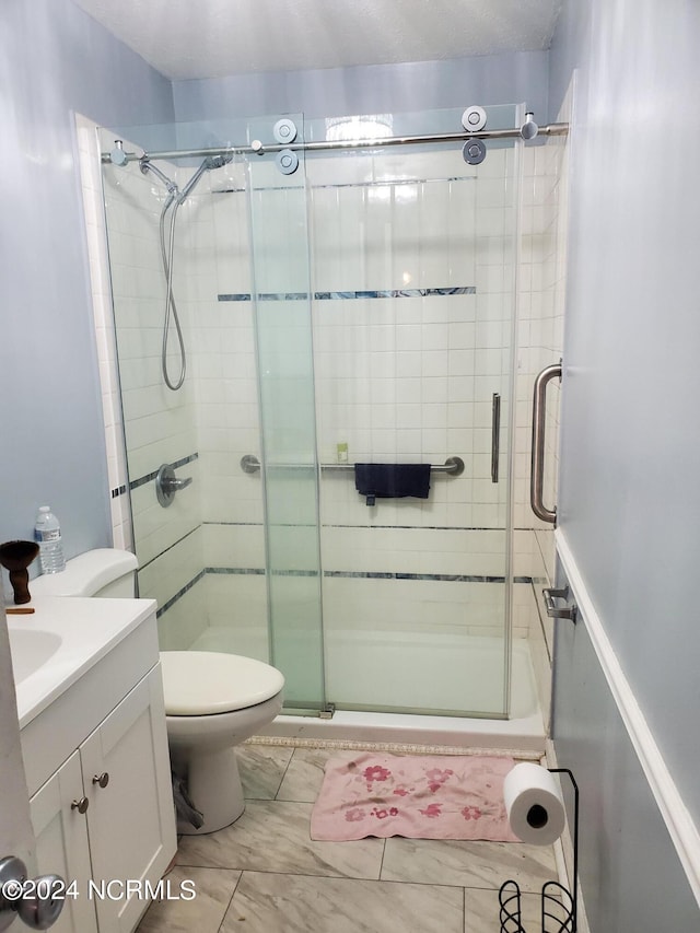 bathroom with vanity, toilet, and an enclosed shower