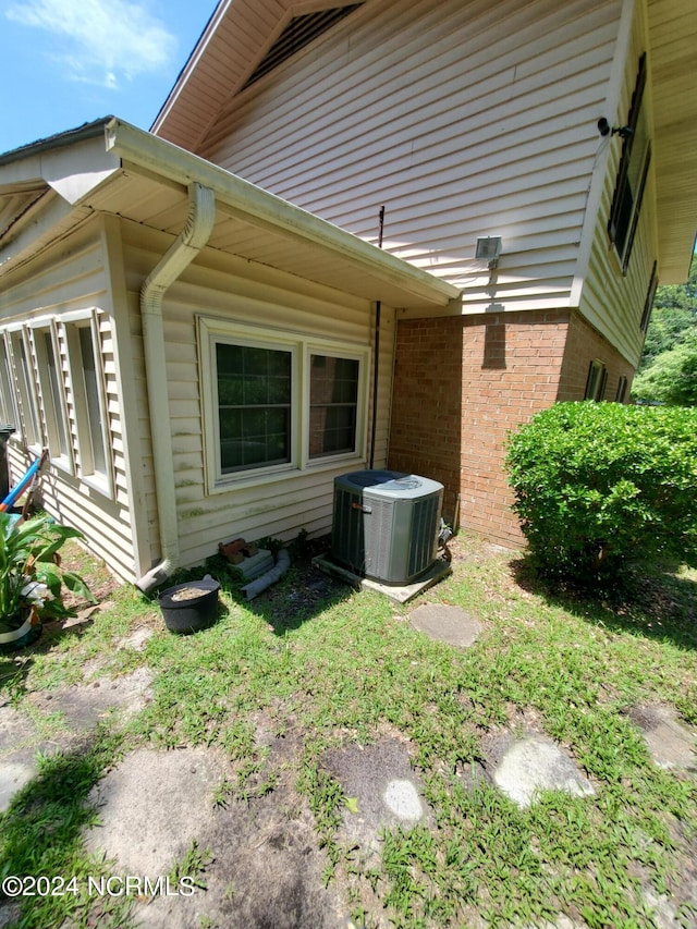 view of side of property featuring central AC unit