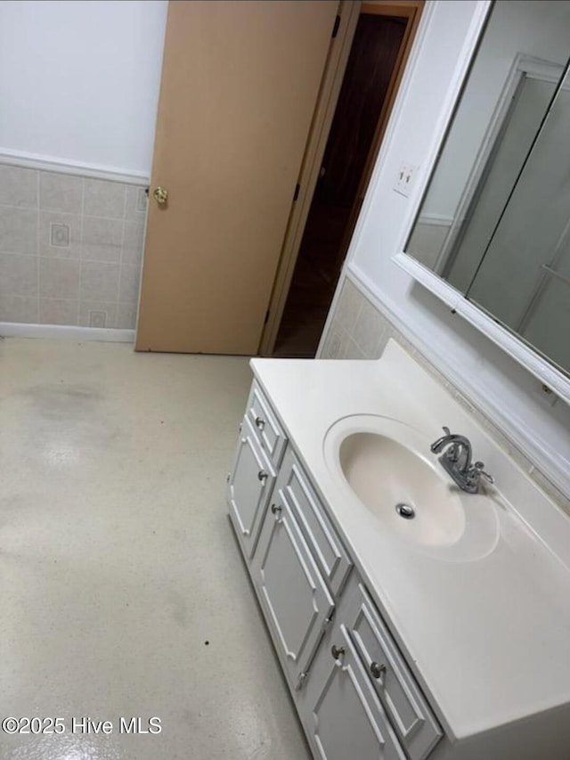 714 Walnut St, Laurinburg, NC 28352 - bathroom with vanity and tile walls