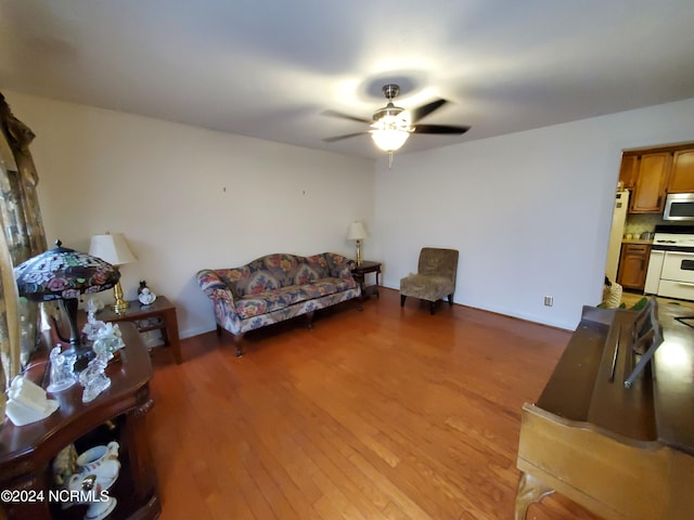 living room featuring ceiling fan and wood-type flooring