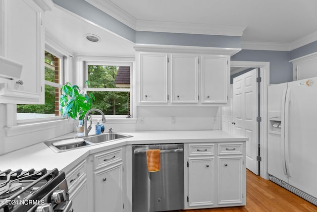 kitchen featuring white cabinets, light countertops, stainless steel dishwasher, white fridge with ice dispenser, and a sink