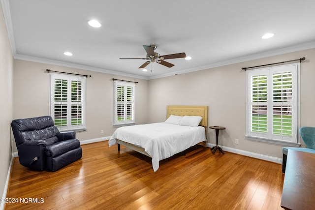 bedroom featuring ceiling fan, ornamental molding, and wood-type flooring