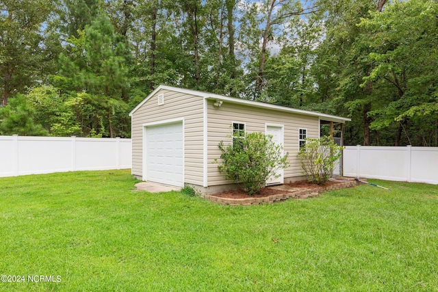 exterior space featuring a garage and a lawn