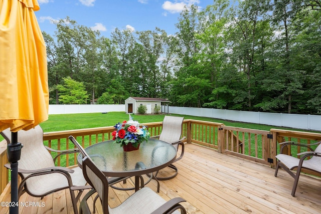 deck with a yard and an outbuilding