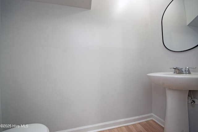 bathroom featuring hardwood / wood-style floors and toilet