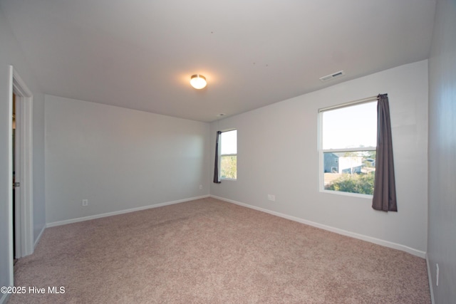 unfurnished room with light carpet