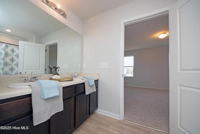 bathroom with hardwood / wood-style floors and vanity