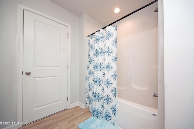 bathroom featuring shower / bath combo and hardwood / wood-style flooring