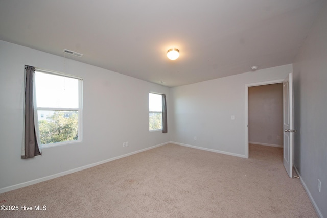 carpeted spare room with plenty of natural light