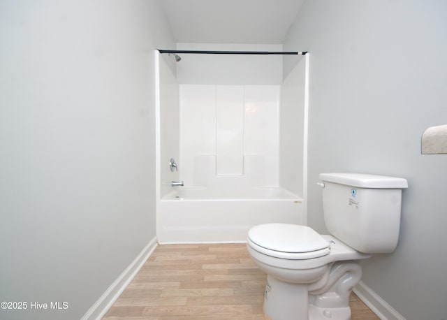 bathroom featuring hardwood / wood-style floors, toilet, and shower / tub combination