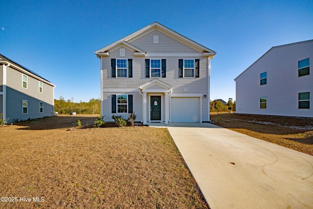 view of front of property featuring a garage and a front lawn