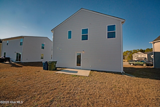 back of property featuring a lawn