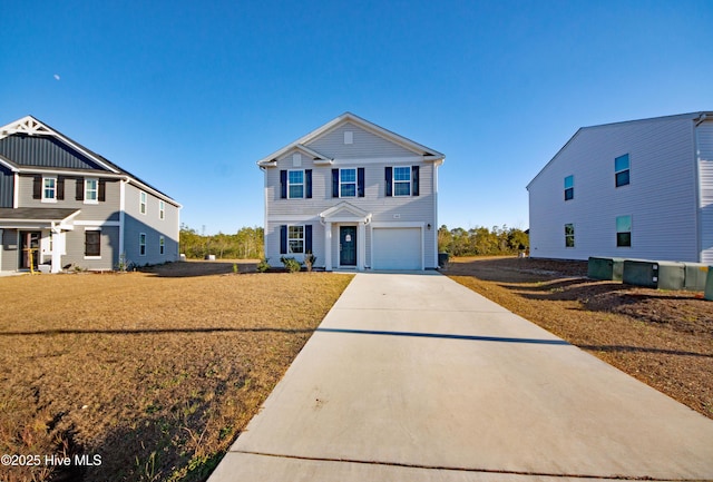 view of front of property with a front yard and a garage