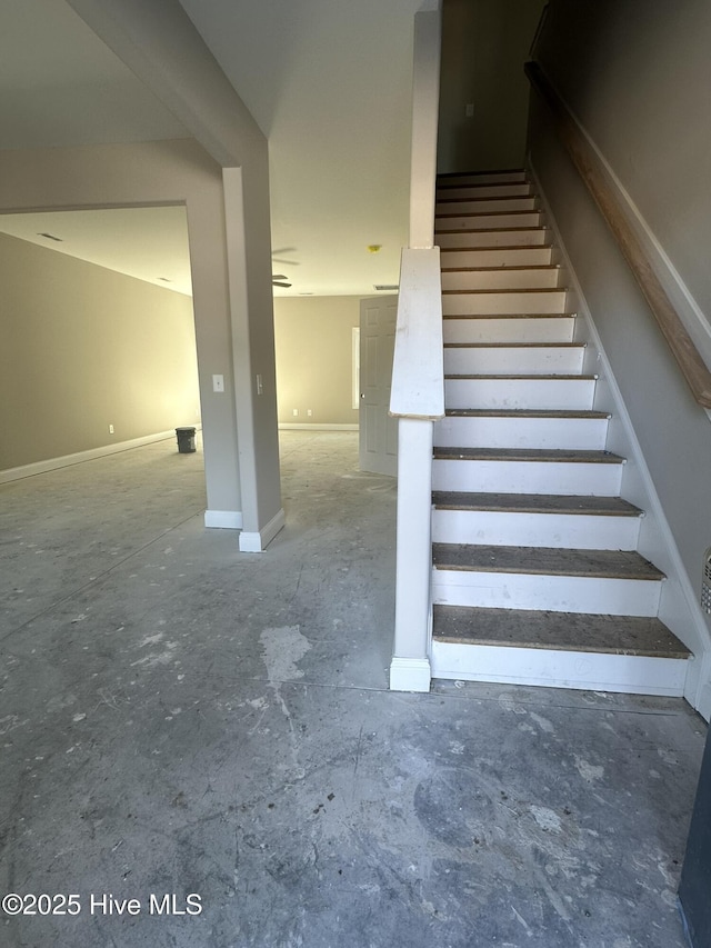 staircase featuring baseboards