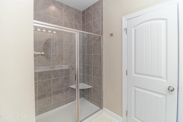 bathroom with a shower with door