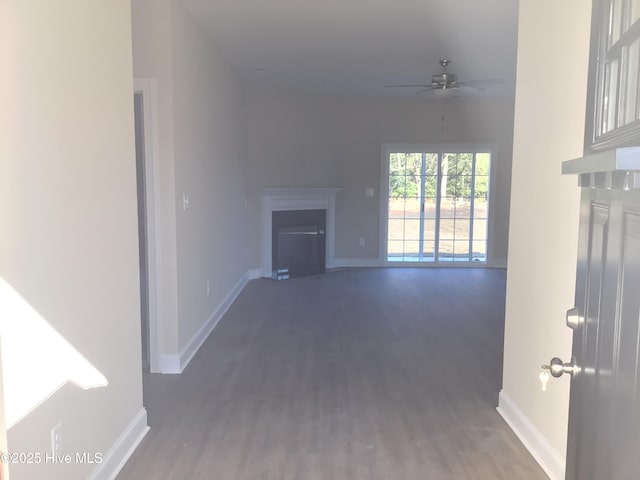 unfurnished living room with hardwood / wood-style floors and ceiling fan