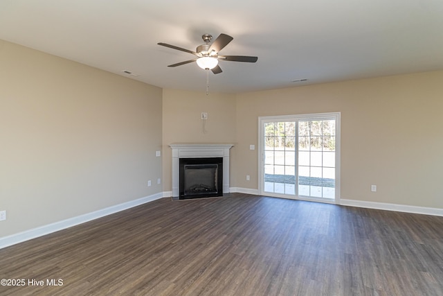 unfurnished living room with dark hardwood / wood-style flooring and ceiling fan