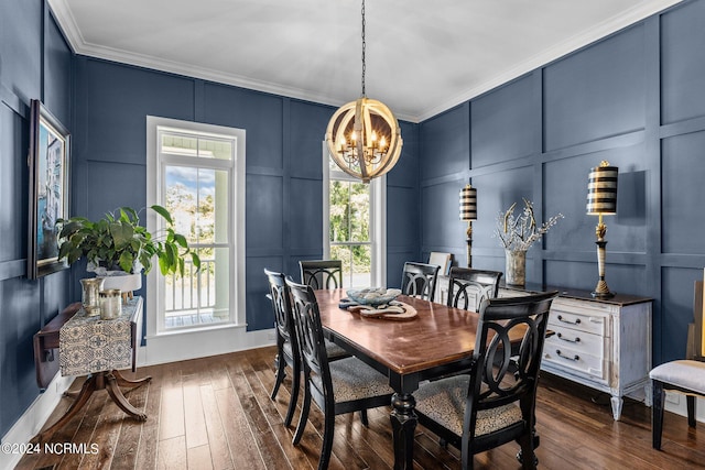 dining area featuring dark hardwood / wood-style flooring, a notable chandelier, and ornamental molding