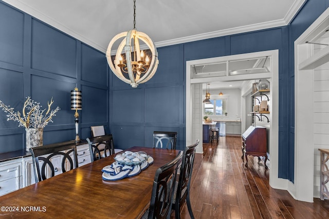 dining area featuring ornamental molding, dark wood-type flooring, and a chandelier