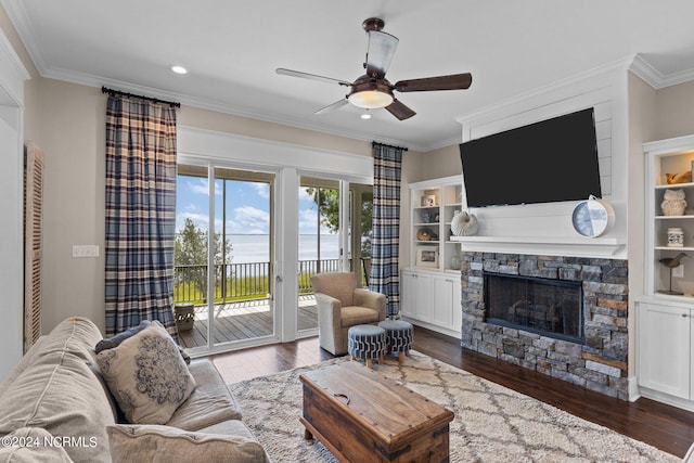 living room featuring crown molding, wood-type flooring, and a fireplace