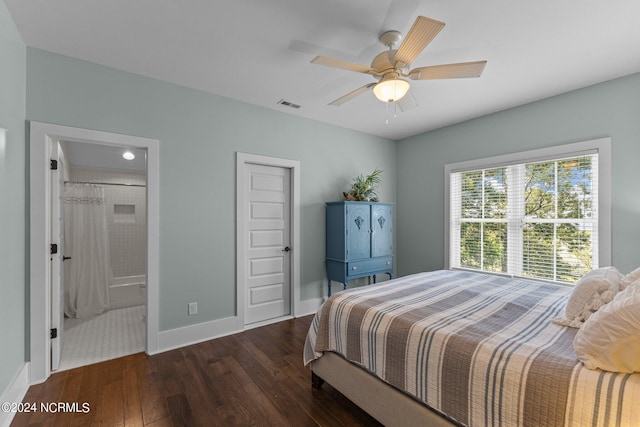 bedroom with ensuite bath, dark hardwood / wood-style floors, and ceiling fan