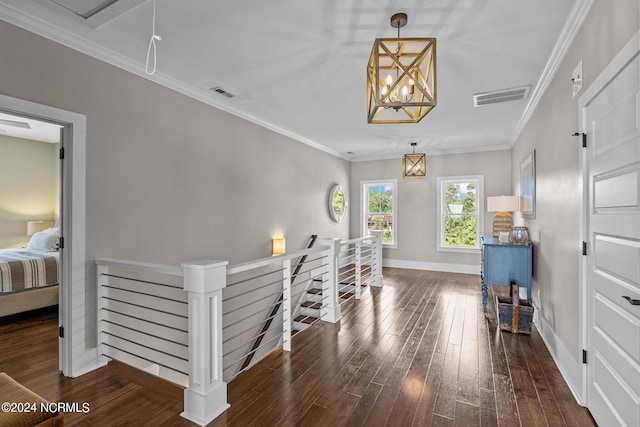 interior space featuring visible vents, an upstairs landing, and wood finished floors