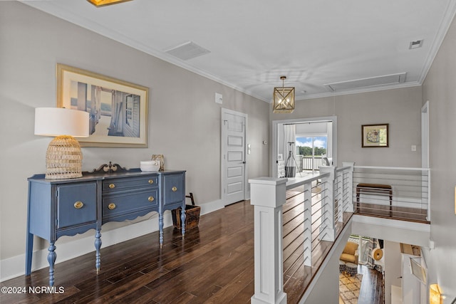 interior space featuring dark wood-style floors, visible vents, crown molding, and an upstairs landing