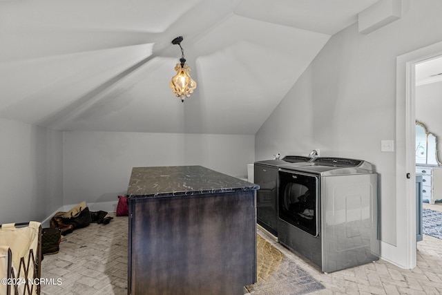 laundry room featuring brick floor, laundry area, baseboards, and washer and clothes dryer