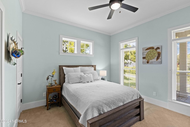 bedroom with light carpet, crown molding, and ceiling fan