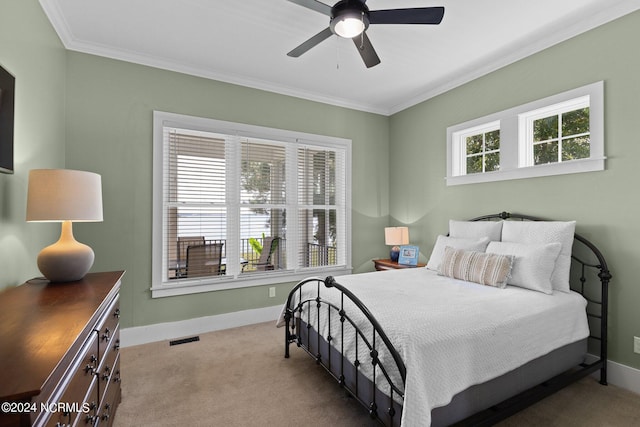 carpeted bedroom with visible vents, baseboards, and crown molding