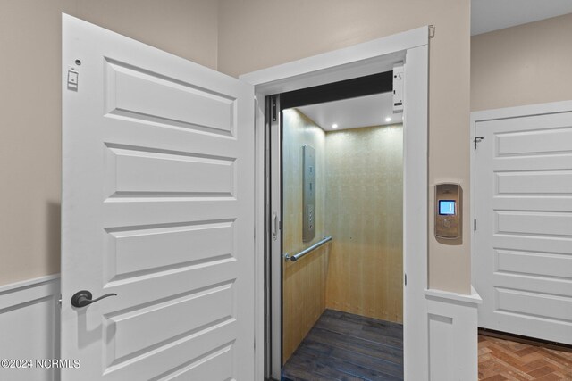 interior space featuring hardwood / wood-style flooring and elevator