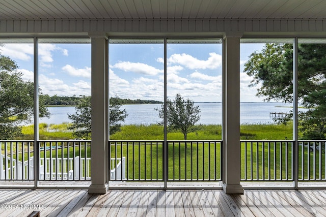 unfurnished sunroom with a water view