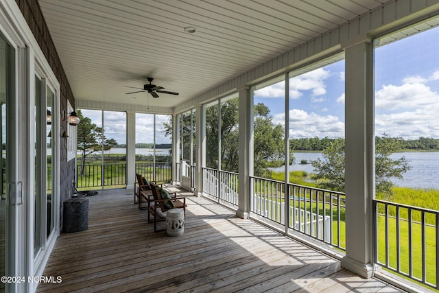 unfurnished sunroom with plenty of natural light and a water view