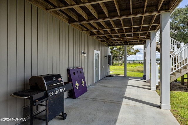 view of patio featuring stairway, grilling area, and a carport