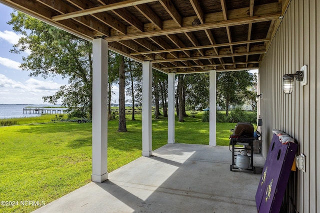 view of patio featuring grilling area and a water view