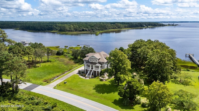 drone / aerial view featuring a water view and a forest view