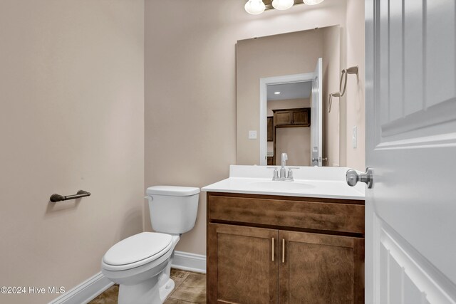 bathroom featuring vanity, tile patterned floors, and toilet