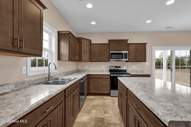 kitchen featuring plenty of natural light, sink, dark brown cabinetry, and stainless steel appliances