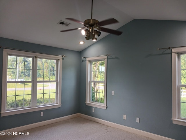 spare room with carpet, ceiling fan, and vaulted ceiling